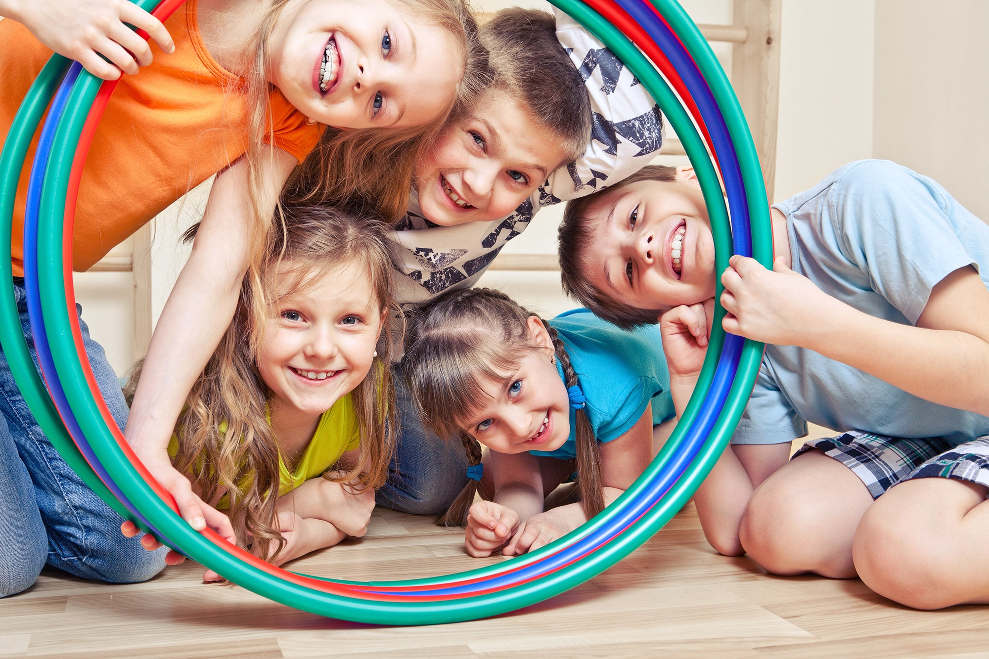 Children posing within a circular object.