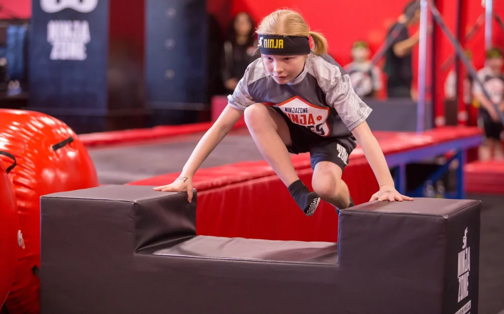 Child jumping over an obstacle.